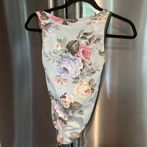 Eleve leo.  Floral with dark olive trim and mesh with open back.